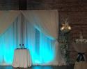 12-Can Up-Lighting Units w/Color Programming @ $45/each.

40-Voile (Sheer White) Draping Available measuring 120" W x 15' Long @ $25/each. (Two Drapes pictured.)

Like New Condition.

(Florals & Other Items Pictured Not Included.)