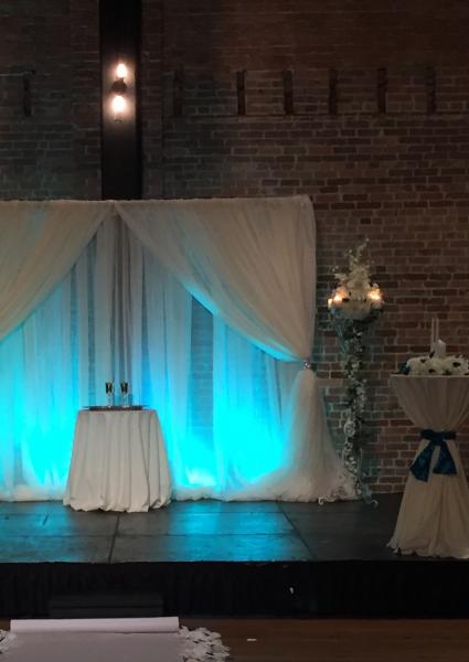 12-Can Up-Lighting Units w/Color Programming @ $45/each.

40-Voile (Sheer White) Draping Available measuring 120" W x 15' Long @ $25/each. (Two Drapes pictured.)

Like New Condition.

(Florals & Other Items Pictured Not Included.)