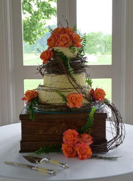 Orange roses and grapevine brides cake